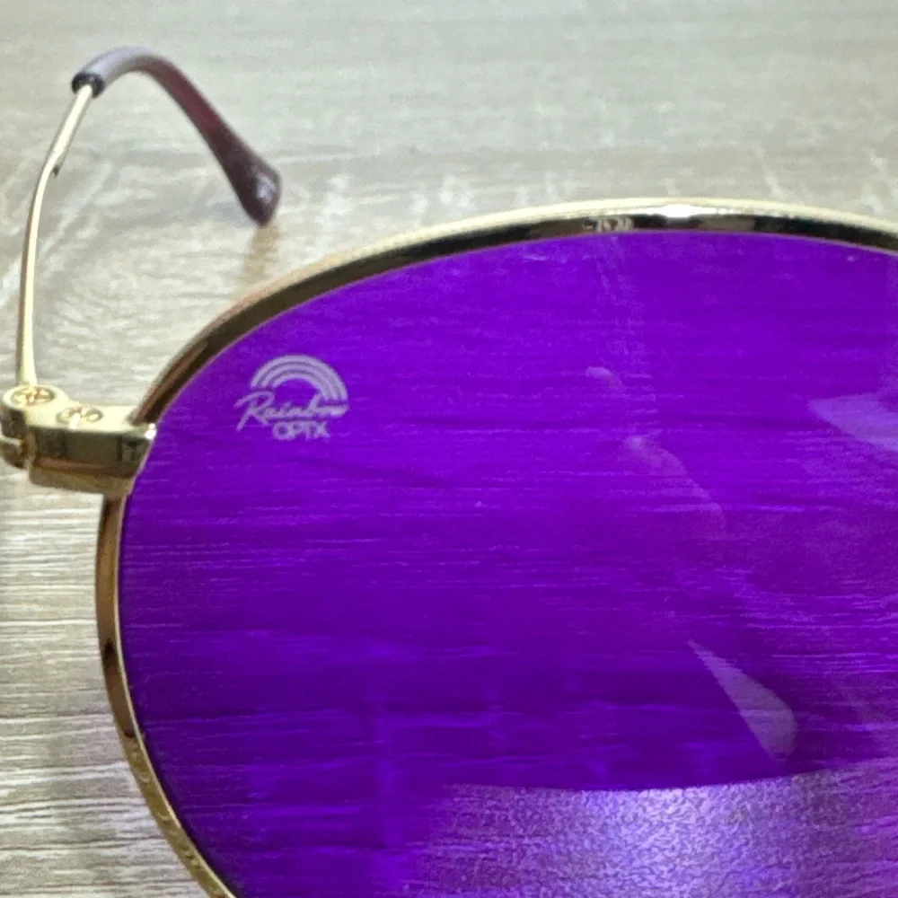 Rainbow OPTX Round sunglasses a gold metal frame and indigo purple lenses